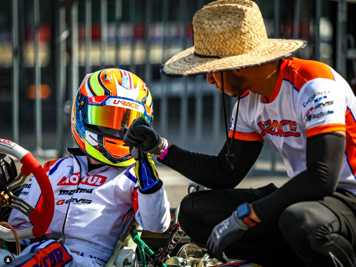 URace Academy coach speaking with a young kart driver