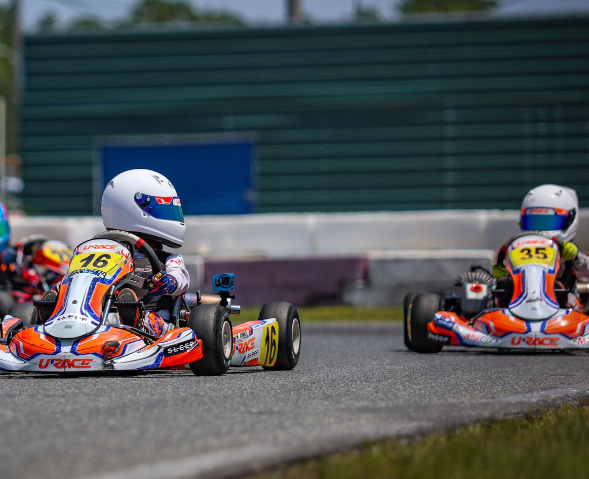 URace Academy drivers competing on a kart track