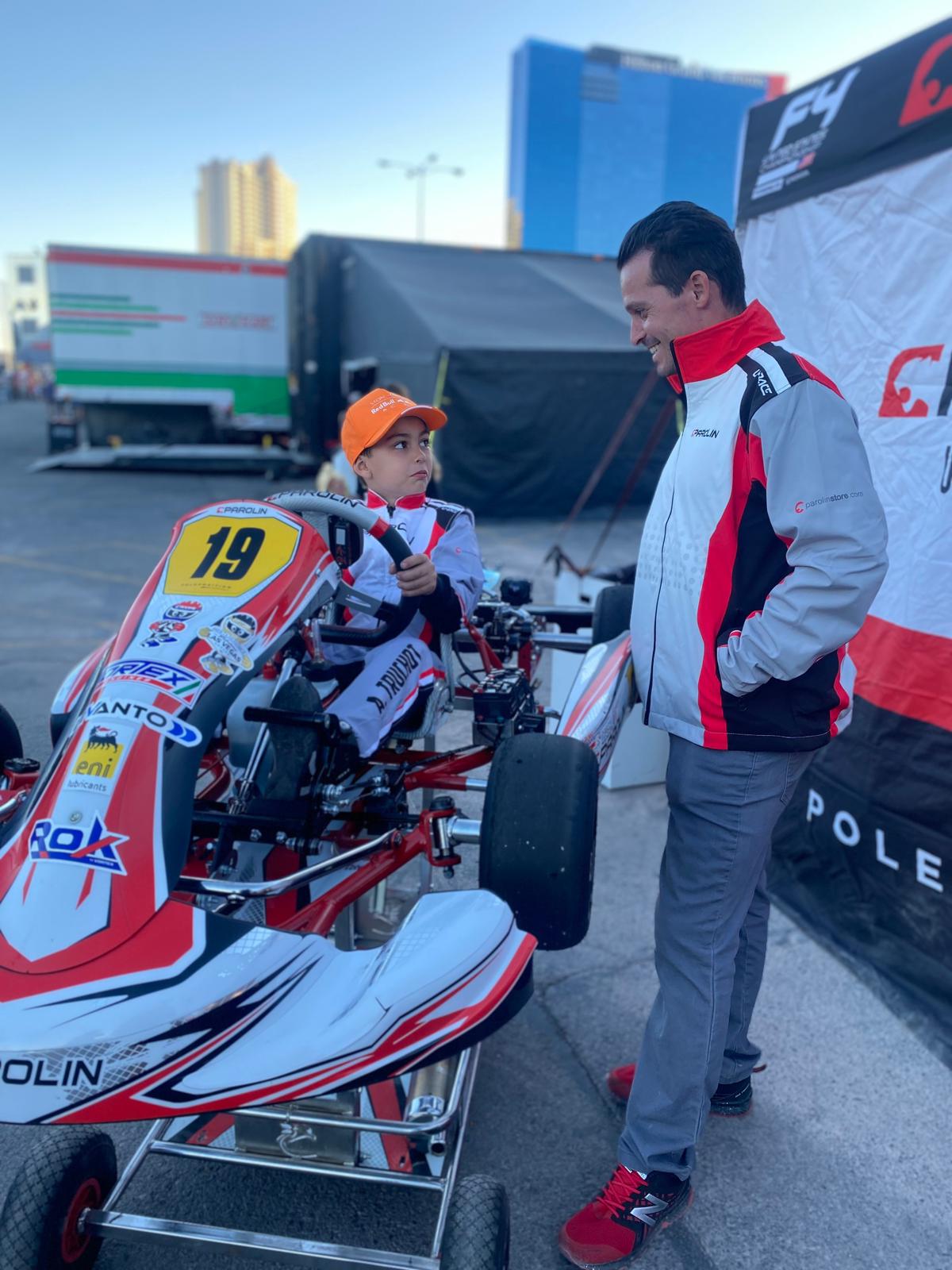Young kart driver receiving trackside support from the URace team