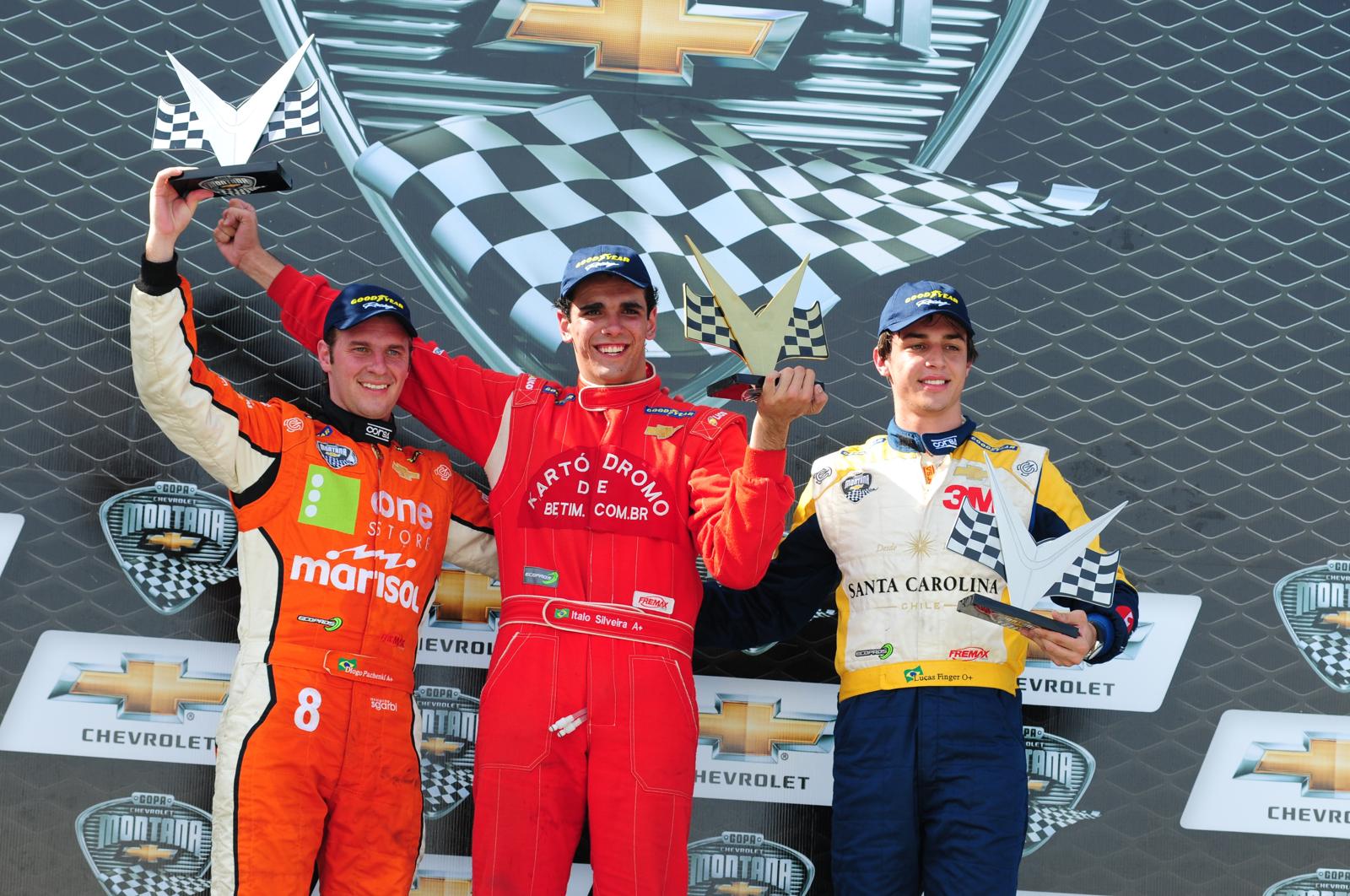 URace drivers celebrating on the podium