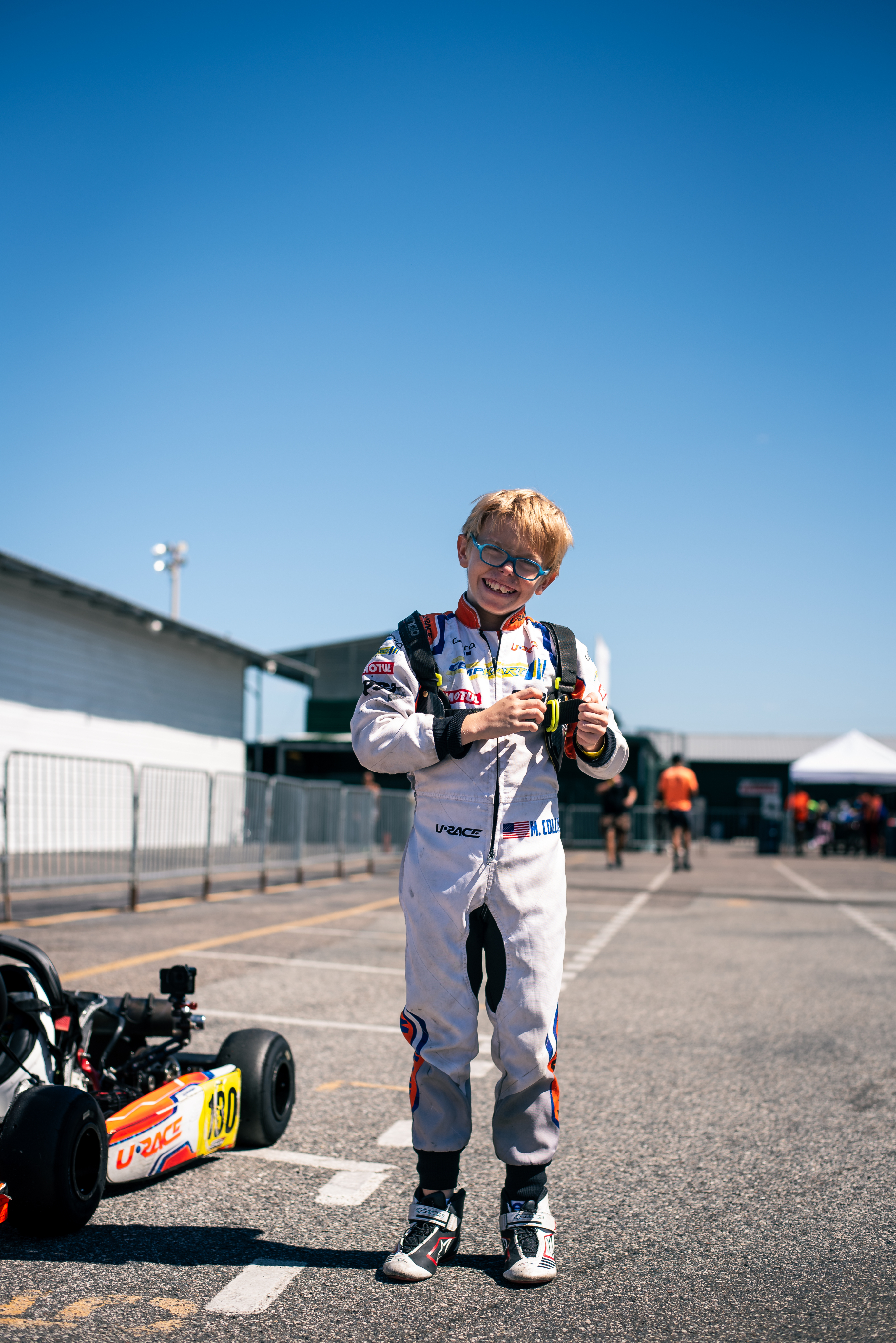 Young Urace driver smiling in paddock