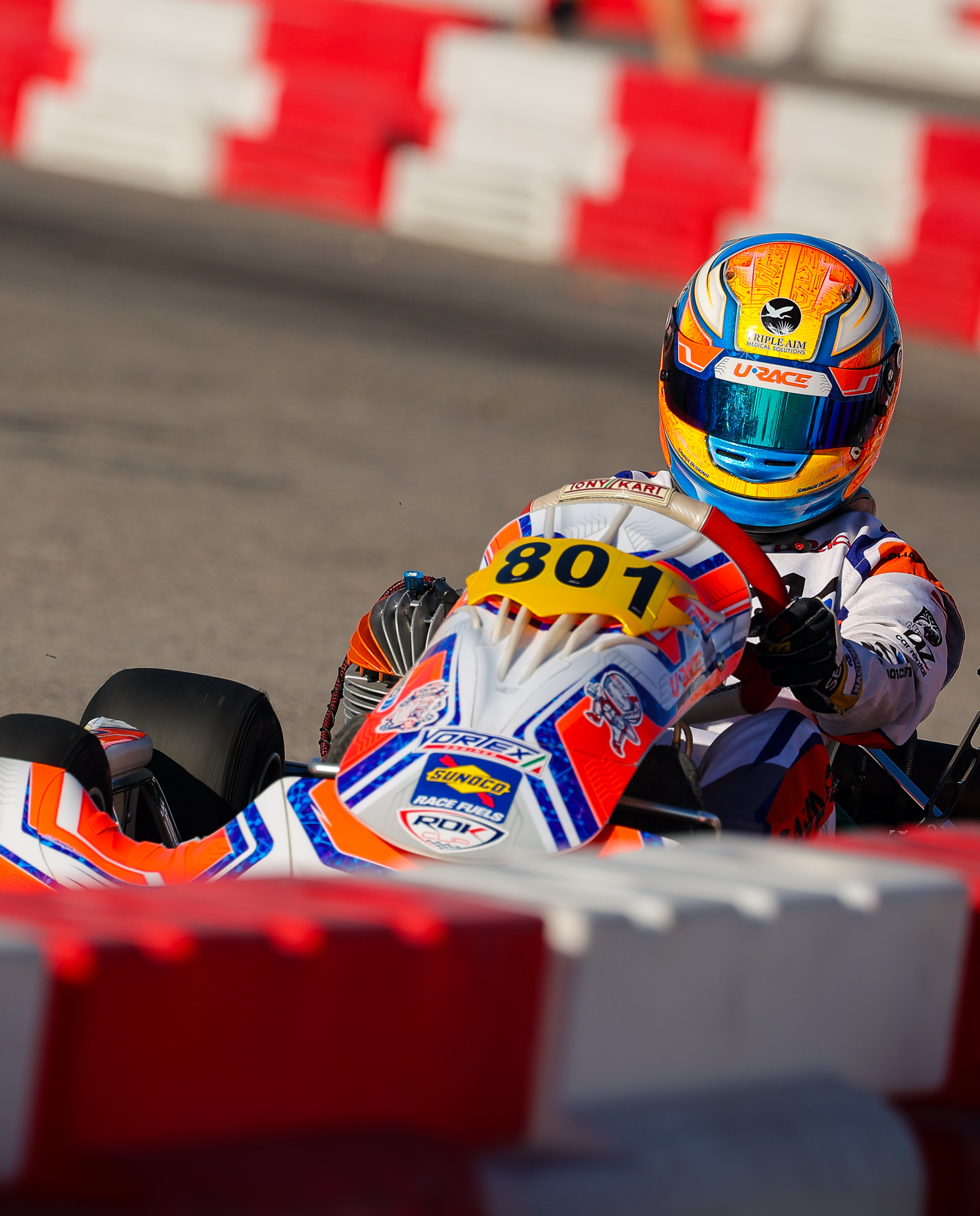 A URace kart driver navigating a corner on track
