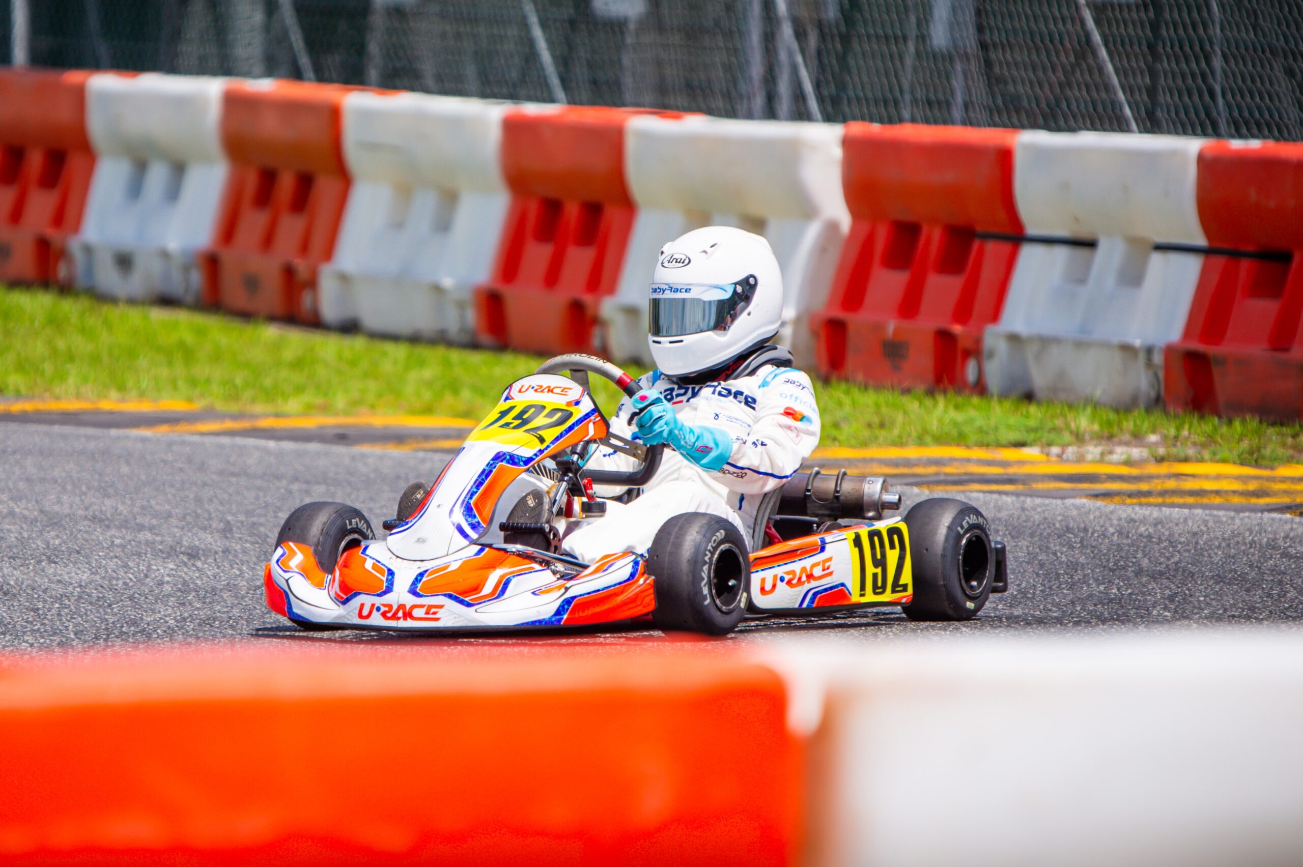 A URACE kart on the grid with its driver and coach